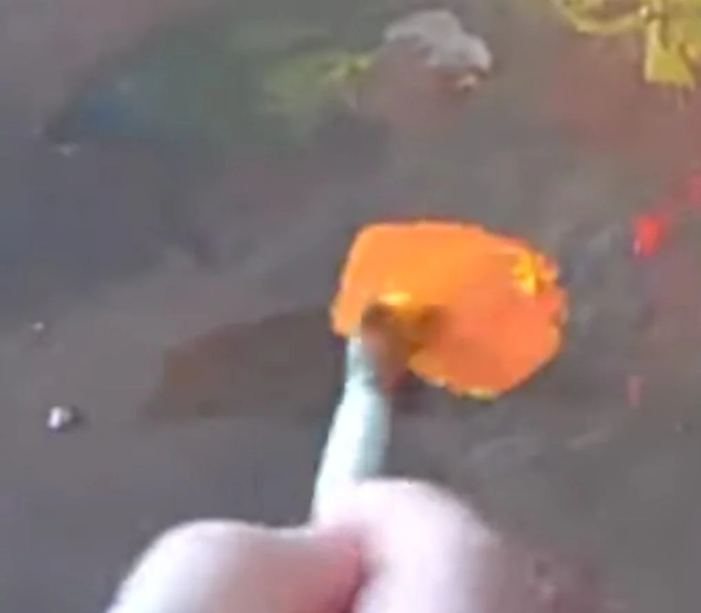 A clean, bright, high-chroma orange mixed on the palette